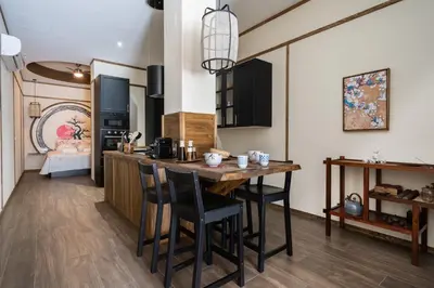 a kitchen with a table and chairs in a room at Le Japonais de COUP DE COEUR APPARTEMENTS in Valencia