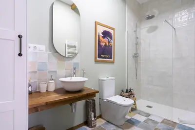 a bathroom with a sink and a toilet and a shower at Le Provençal de COUP DE COEUR APPARTEMENTS in Valencia