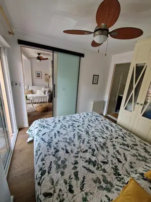 a bedroom with a bed and a ceiling fan at Cozy Rustic Home in Playa Pobla de Farnals