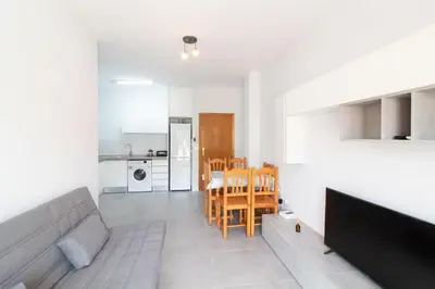 a living room with a couch and a table at Global Vacacional, Apartamento con gran terraza en la playa de Canet in Canet de Berenguer