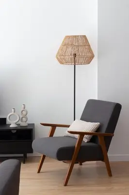a chair and a table with a lamp in a room at VLC HOST - Duque de Gaeta in Valencia
