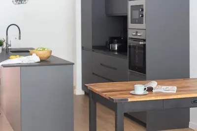 a kitchen with a table with a coffee cup on it at VLC HOST - Duque de Gaeta in Valencia