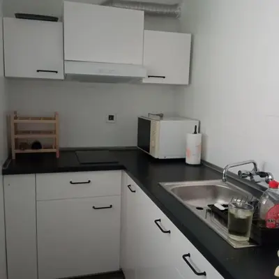 a kitchen with white cabinets and a sink at Mar y castillo in Cullera