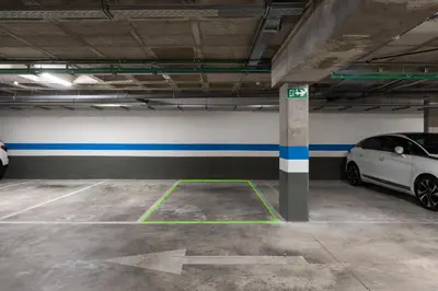 a parking garage with two cars parked in it at Dúplex piscina, parking -Roig Arena -Las Ciencias in Valencia