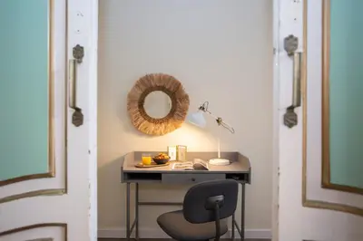 a desk with a chair and a mirror on a wall at SingularStays San Valero in Valencia