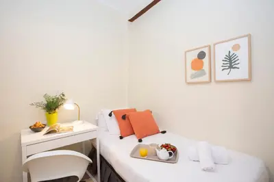 a room with a bed with a desk and a chair at SingularStays San Valero in Valencia