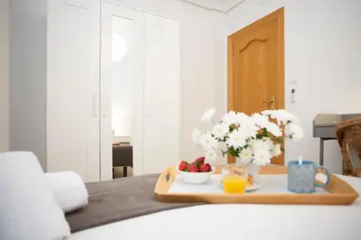 a tray with fruit and flowers on a table at SingularStays Gran Via in Valencia