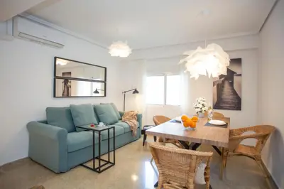 a living room with a blue couch and a table at SingularStays Gran Via in Valencia