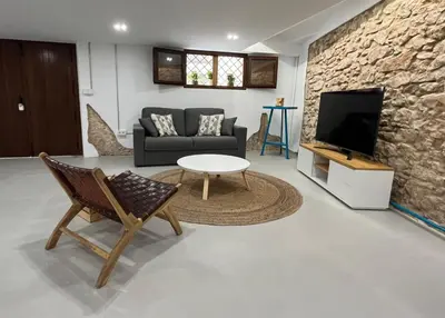 a living room with a couch and a table and a tv at Estudio Pino en casco antiguo VALENCIAYOLE in Valencia