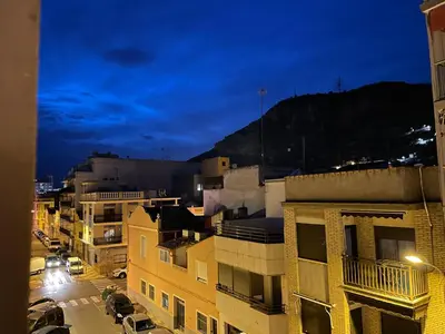 a view of a city at night with buildings at RIU MAR Apartment Cullera in Cullera