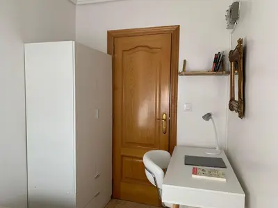a room with a desk and a wooden door at Sagunto in Sagunto