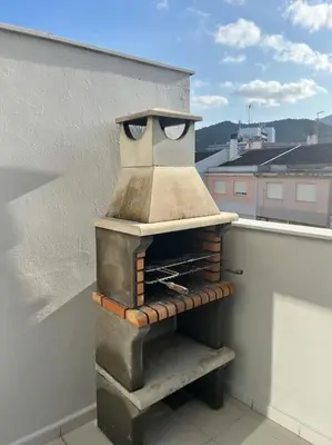 a pizza oven sitting on the side of a building at Terraced house in natural essence in Favareta