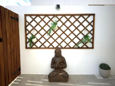 a buddha statue in front of a wall with a mirror at Casa Del Mar, piscina privada frente al mar in Cullera
