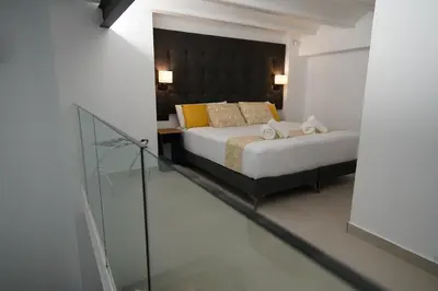 a bedroom with a bed and a glass walk in shower at BET Apartments - Suites Puerto Valencia in Valencia
