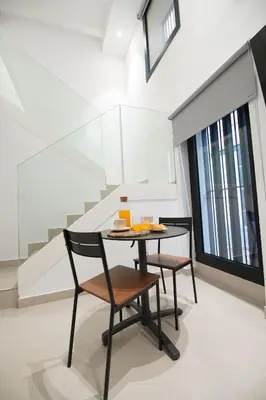 a dining room with a table and two chairs at BET Apartments - Suites Puerto Valencia in Valencia