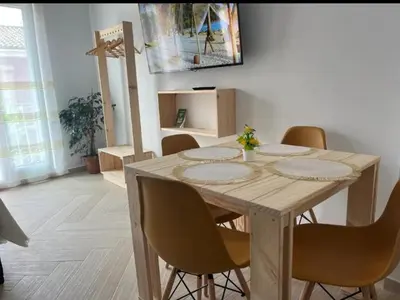 a wooden table with chairs around it in a room at Loft C El Ramellet in Alginet