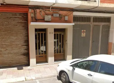 a white car parked in front of a building at DJcumar Apartamento en Cullera comodo y bien ubicado in Cullera