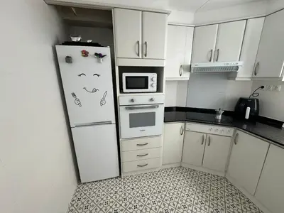 a kitchen with a refrigerator with a face drawn on it at DJcumar Apartamento en Cullera comodo y bien ubicado in Cullera