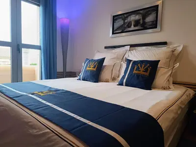 a large bed with blue and gold pillows on it at Lushville - Luxurious Villa with Pool in Valencia in Campo Olivar
