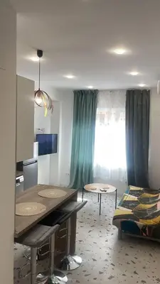 a living room with a table and a bed at Del Mar 1C - New Beach First floor One bed flat in Puerto de Sagunto