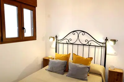 a bedroom with a bed with yellow pillows at Casa típica del Cabanyal in Valencia