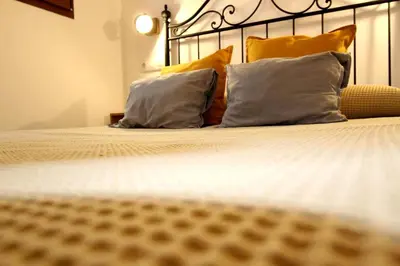 a bed with two pillows and a metal head board at Casa típica del Cabanyal in Valencia