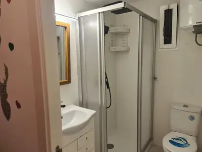 a bathroom with a toilet and a sink at Edificio El Sol in Cullera