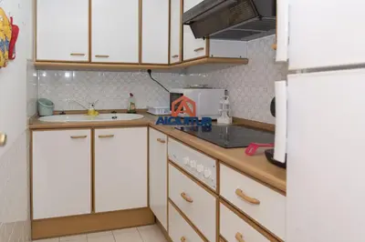 a kitchen with white cabinets and a sink and a refrigerator at Amador, 4-J in Cullera