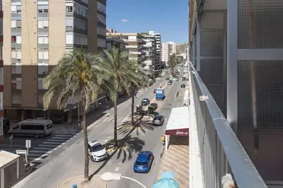 a view of a city street with palm trees and cars at Amador, 4-J in Cullera