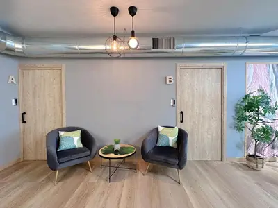two chairs and a table in a room at The POD Suite Hostel Blasco in Valencia
