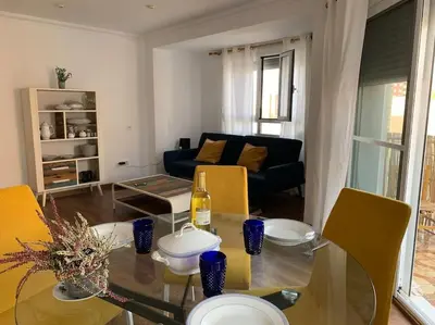 a living room with a glass table and a couch at Sueca 1 in Sueca