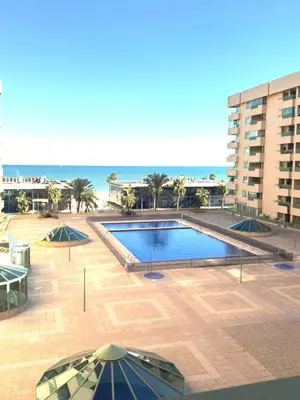 a swimming pool with a view of the beach at BEACH VALENCIA LUXURY B7-23 Apartment with terrace and sea views in Valencia