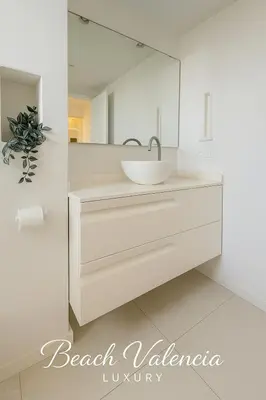 a white bathroom with a sink and a mirror at BEACH VALENCIA LUXURY B7-23 Apartment with terrace and sea views in Valencia