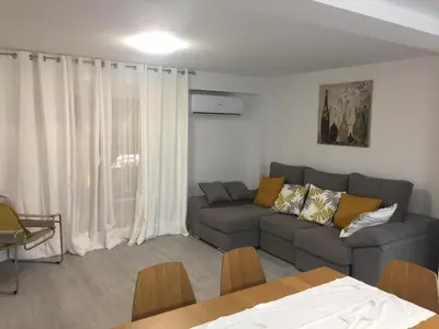 a living room with a couch and a table at NEW STYLISH BEACH FRONT APARTMENT in Cullera
