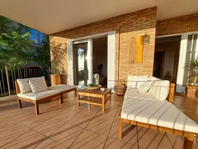 a patio with two couches and a coffee table at Casa en Valencia, piscina, cerca de golf, playas, moto Gp in Valencia