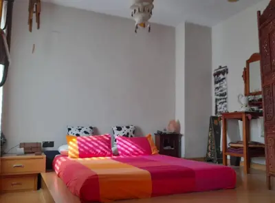 a bedroom with a large bed with colorful pillows at Zanzibar Beach Puzol relax en la playa cerca de Sagunto y Valencia in Puzol