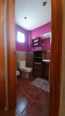 a bathroom with purple walls and a toilet and a sink at Zanzibar Beach Puzol relax en la playa cerca de Sagunto y Valencia in Puzol