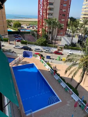 a swimming pool at a resort with a playground at Sol y Mar in Puebla de Farnals
