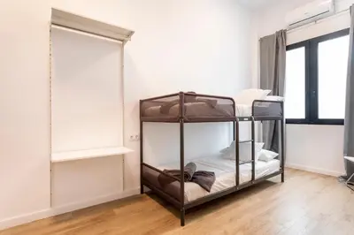 a room with two bunk beds and a window at 10 pax, AC, Wifi gratis, Ciudad Artes y Ciencias in Valencia