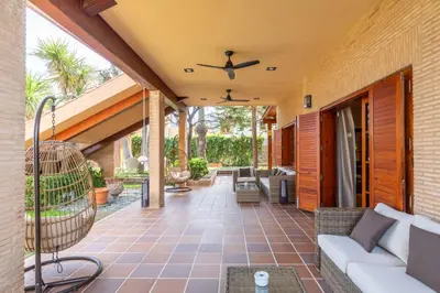 an outdoor patio with a couch and a ceiling fan at Dolce Vita B&B - Only Adults in Valencia