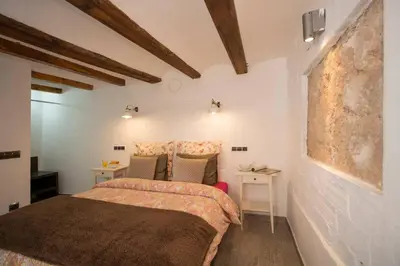 a bedroom with a bed and a desk in it at Next to Central Market, Cathedral and Town Hall in Valencia