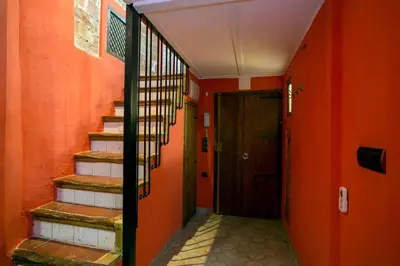 an orange hallway with stairs and a door at Next to Central Market, Cathedral and Town Hall in Valencia