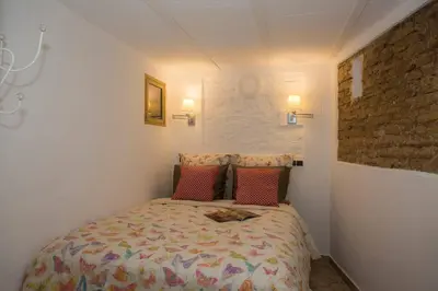 a small bedroom with a bed in a room at Next to Central Market, Cathedral and Town Hall in Valencia