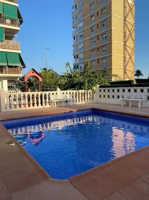 a large swimming pool in a building with buildings at Brisa Marina in Las Canteras