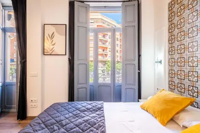 a bedroom with a blue door and a bed at Classy Studio Apartment with Unique Design in Valencia