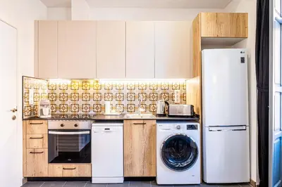 a kitchen with a refrigerator and a washer and dryer at Classy Studio Apartment with Unique Design in Valencia
