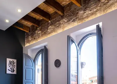 a room with two windows and a brick wall at Spacious Penthouse with Massive Terrace in Valencia
