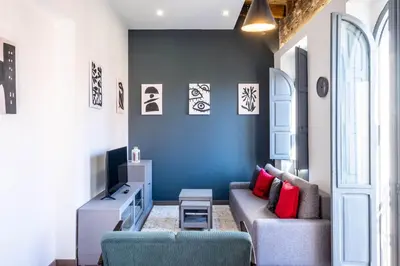 a living room with a couch and a blue wall at Spacious Penthouse with Massive Terrace in Valencia