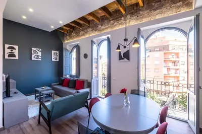 a living room with a table and a couch at Spacious Penthouse with Massive Terrace in Valencia