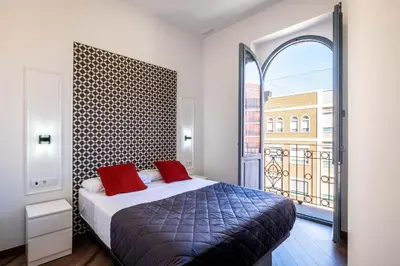 a bedroom with a bed and a large window at BrightHouse with Warm and Friendly Vibes in Valencia
